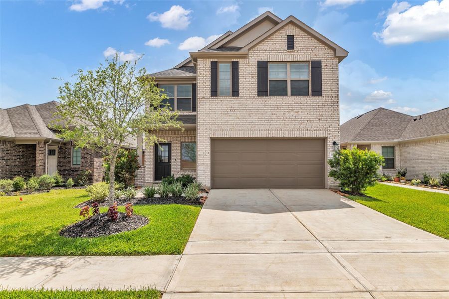 Front exterior of a new home in Marvida, Cypress, TX, highlighting curb appeal (Image 19). Front exterior of a new home in Marvida, Cypress, TX, highlighting curb appeal (Image 19).