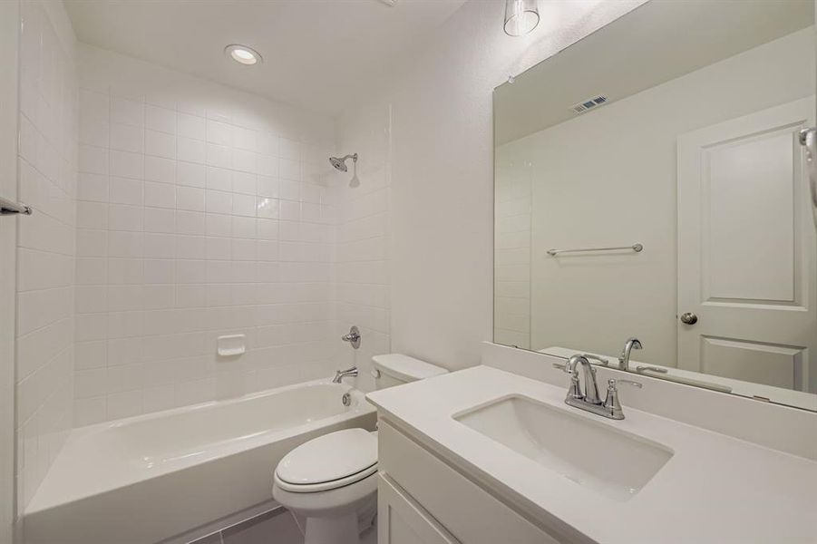Full bath with shower / bath combination, vanity, tile patterned floors, and recessed lighting Full bath with shower / bath combination, vanity, tile patterned floors, and recessed lighting