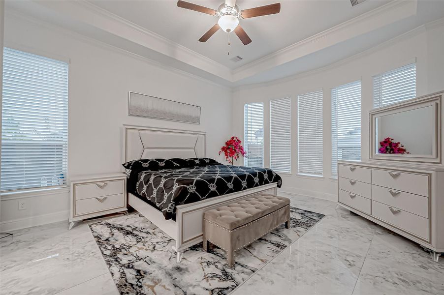 First Primary Suite: Curved wall of windows for abundant natural light, Tray ceiling & double-door entry to the ensuite, Luxurious upgraded shower with bench & mud set, Jacuzzi tub & double vanities, Expansive walk-in closet with built-in shelving & ample hanging space.