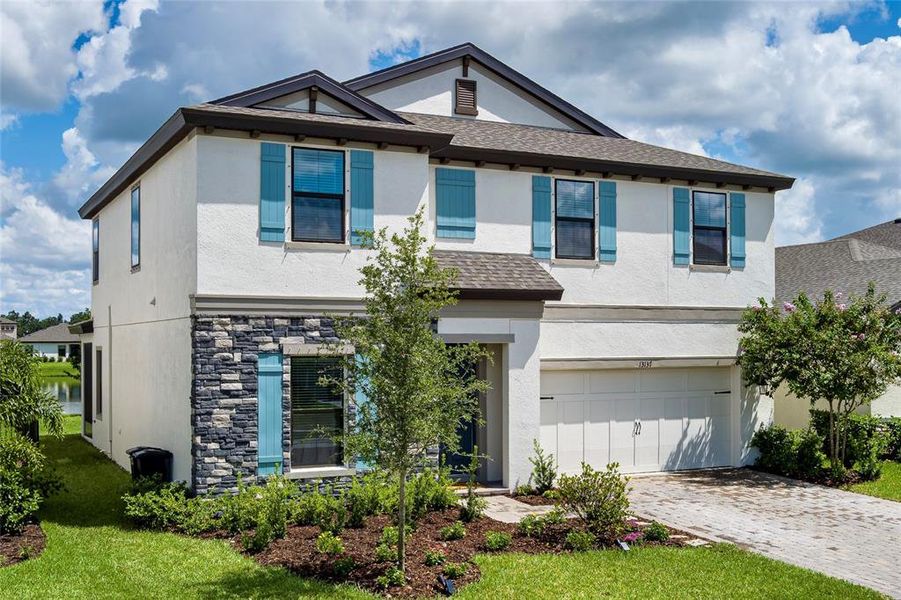 Front exterior of a new home in Crosswind Point, Parrish, FL, highlighting curb appeal (Image 26).