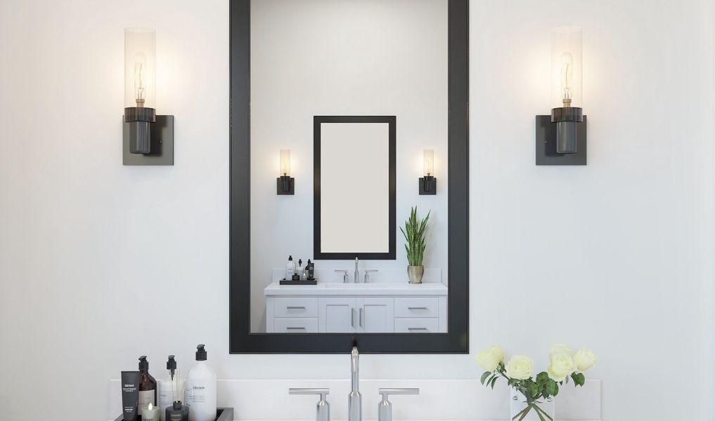 Matte black light fixtures and framed mirror in primary