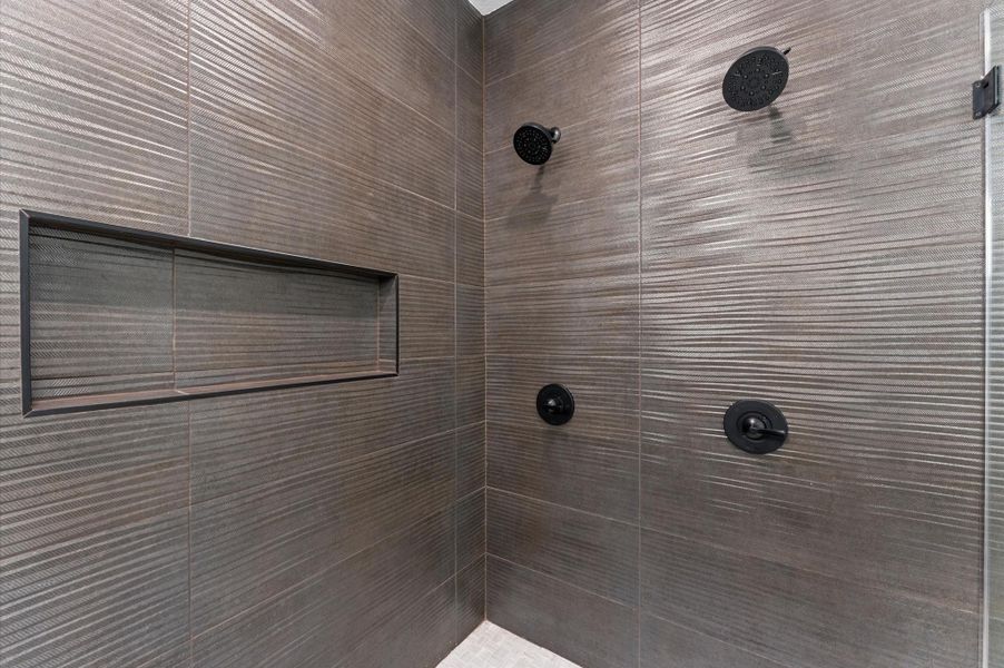 Two shower heads and lots of room on the recessed shelf for shampoo, conditioner, and body washes.