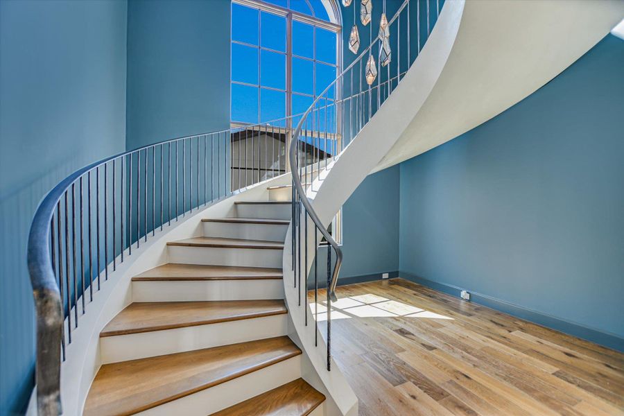 Stairway featuring wood-type flooring and baseboards