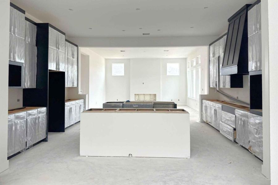 Kitchen featuring a kitchen island, premium range hood, and concrete flooring