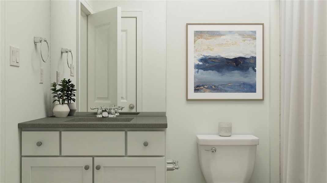 Half bathroom featuring vanity and toilet Half bathroom featuring vanity and toilet