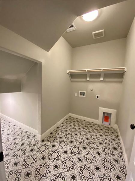 Custom decorative tile in the utility room Custom decorative tile in the utility room