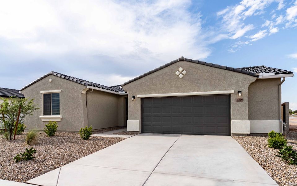 Front exterior of a new home in Rancho Mirage, Maricopa, AZ, highlighting curb appeal (Image 2). Front exterior of a new home in Rancho Mirage, Maricopa, AZ, highlighting curb appeal (Image 2).