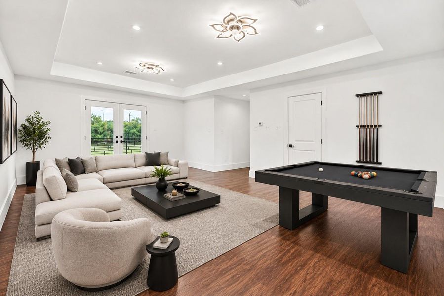 *Virtually Staged*Spacious upstairs game room designed for entertaining with contemporary styling, oversized layout, sleek and comfortable lounge space with two separate balconys