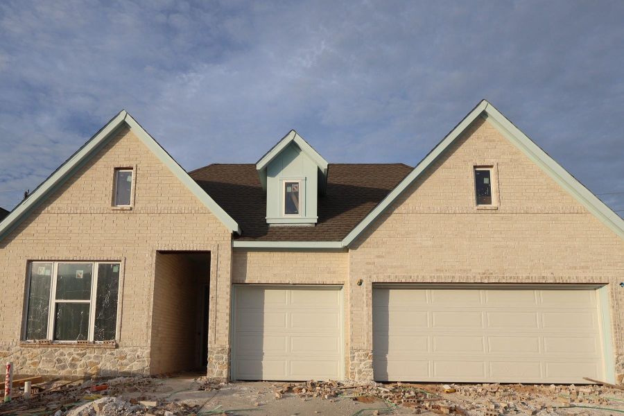 Front exterior of a new home in Meridiana - Ascent Collection, Manvel, TX, highlighting curb appeal (Image 2). Front exterior of a new home in Meridiana - Ascent Collection, Manvel, TX, highlighting curb appeal (Image 2).