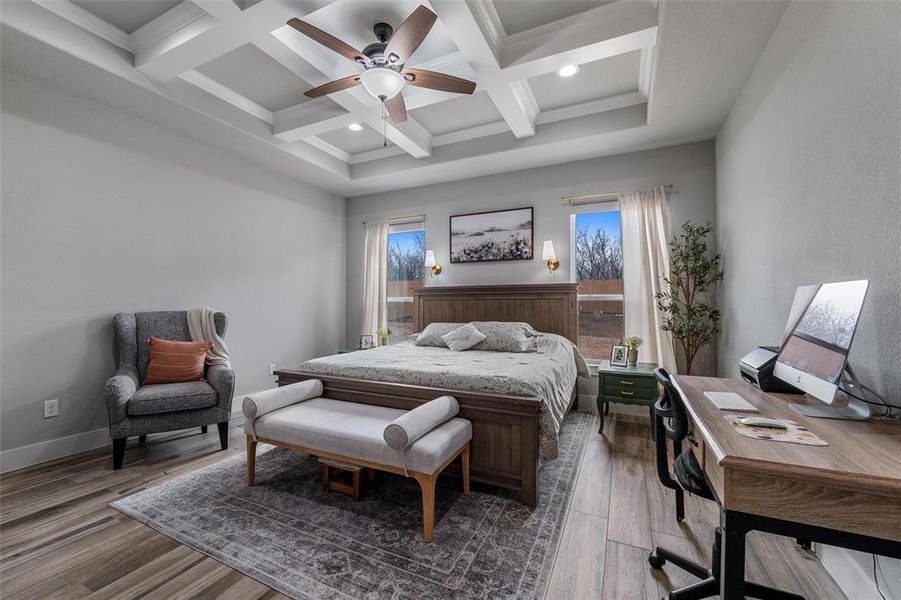 Bedroom featuring beamed ceiling, ceiling fan, wood-type flooring, and coffered ceiling