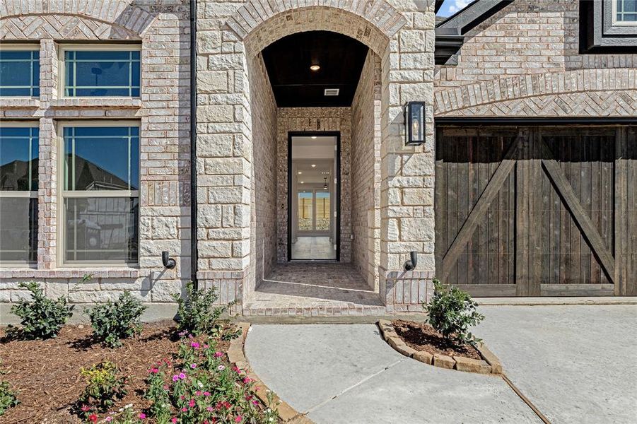 Front exterior of a new home in Painted Tree Woodland District 50, McKinney, TX, highlighting curb appeal (Image 2).
