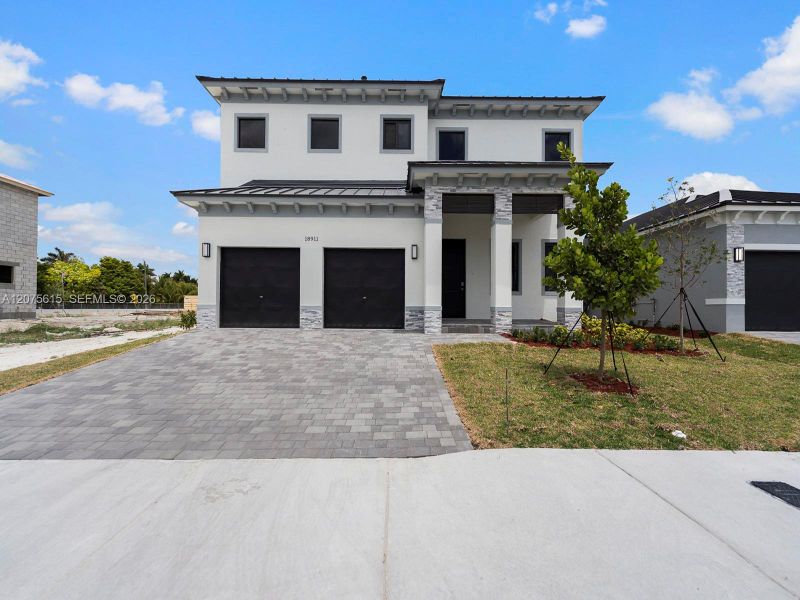Front exterior of a new home in , Homestead, FL, highlighting curb appeal (Image 2). Front exterior of a new home in , Homestead, FL, highlighting curb appeal (Image 2).