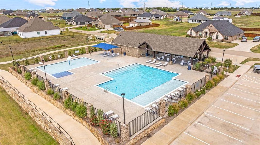 Community pool featuring a patio area and a residential view