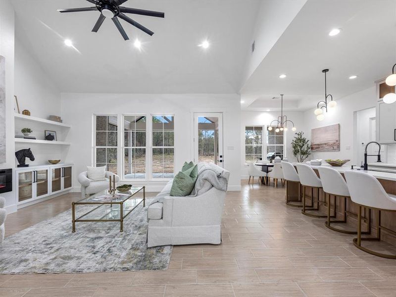 The open concept allows you to truly appreciate every inch of this home's space. The living room perfectly oversees the back patio, along with allowing the perfect amount of space to the kitchen island.