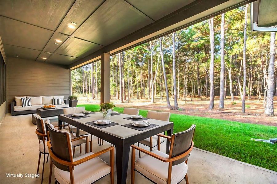 Extended covered patio overlooking the mature trees.