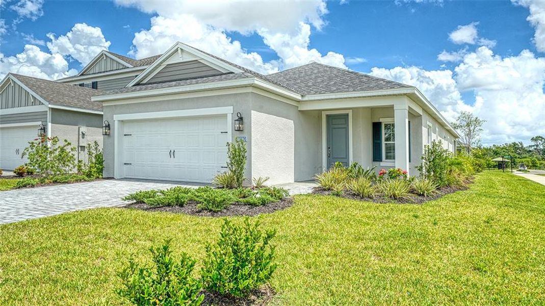 Front exterior of a new home in Wildleaf at North River Ranch, Parrish, FL, highlighting curb appeal (Image 2).