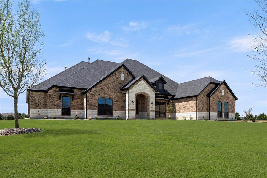 Front exterior of a new home in Las Brisas at Stoney Creek, Sunnyvale, TX, highlighting curb appeal (Image 2). Front exterior of a new home in Las Brisas at Stoney Creek, Sunnyvale, TX, highlighting curb appeal (Image 2).
