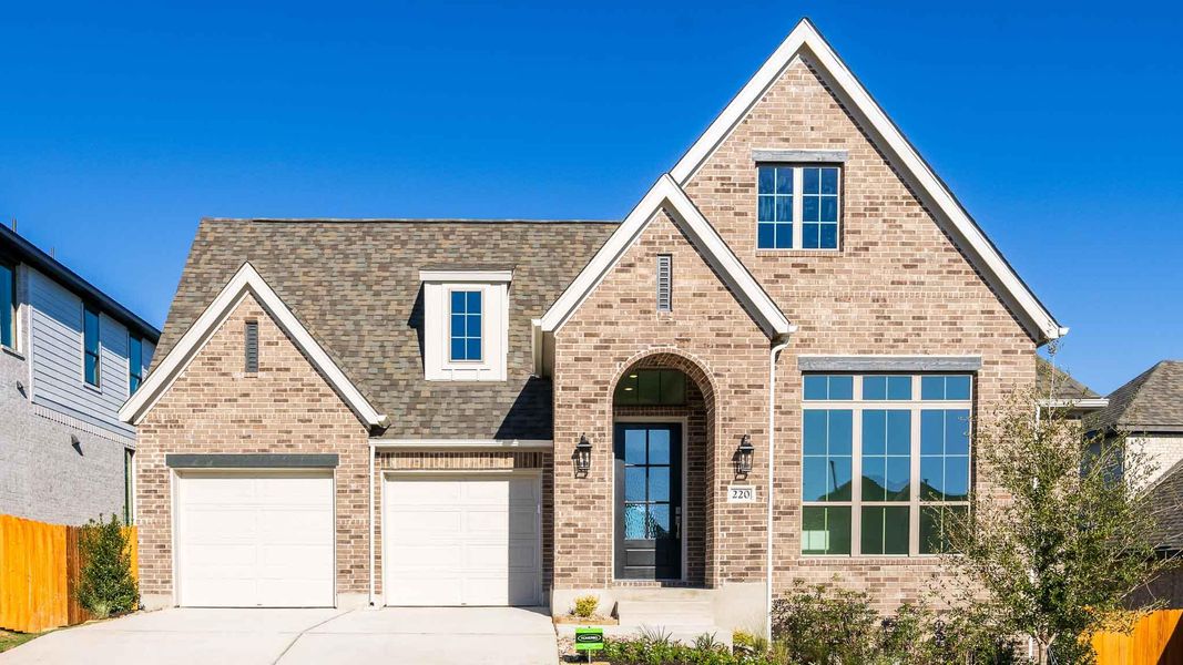Front exterior of a new home in Lariat 60', Liberty Hill, TX, highlighting curb appeal (Image 2). Front exterior of a new home in Lariat 60', Liberty Hill, TX, highlighting curb appeal (Image 2).