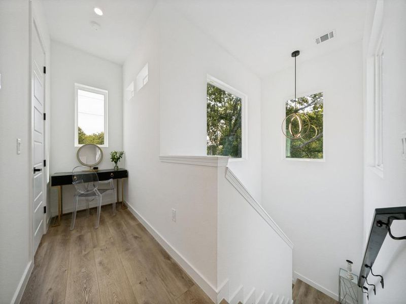 Artfully designed stairwell provides a welcoming flow between levels, enhanced by abundant natural light. Artfully designed stairwell provides a welcoming flow between levels, enhanced by abundant natural light.