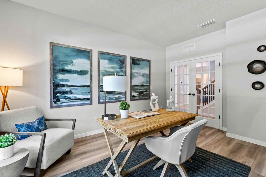 A living room with a table and chairs. A living room with a table and chairs.