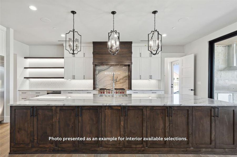 Kitchen with a spacious island, light stone countertops, hardwood / wood-style flooring, and tasteful backsplash