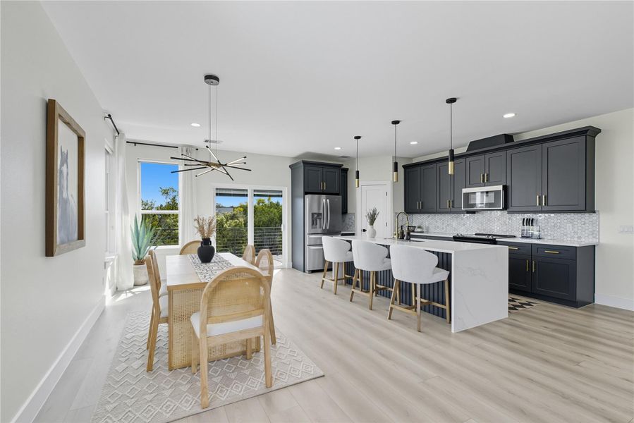 Dining room with a chandelier, light wood-style floors, and recessed lighting