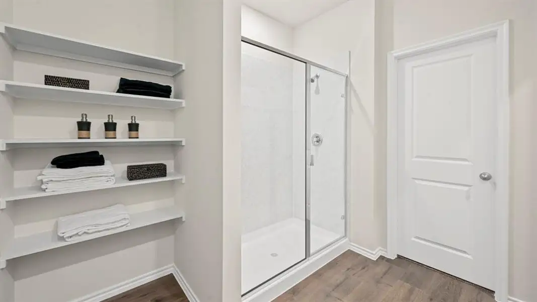 Bathroom featuring dark wood-style flooring and a stall shower