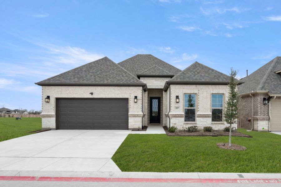 Front exterior of a new home in Ladera at Timberbrook, Justin, TX, highlighting curb appeal (Image 23). Front exterior of a new home in Ladera at Timberbrook, Justin, TX, highlighting curb appeal (Image 23).