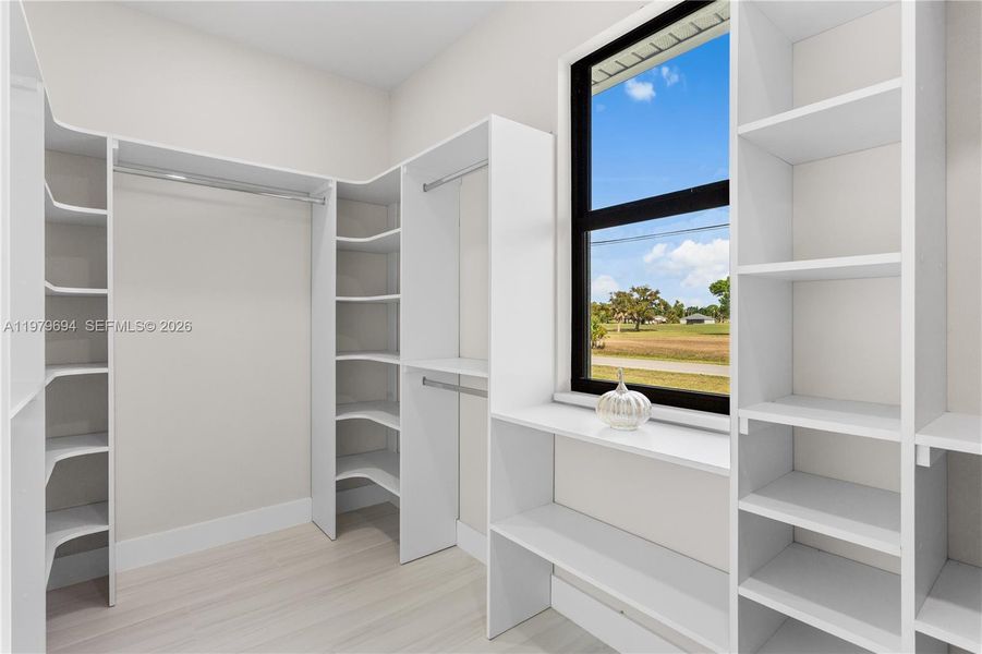 Primary Bedroom large close with custom made cabinetry Primary Bedroom large close with custom made cabinetry