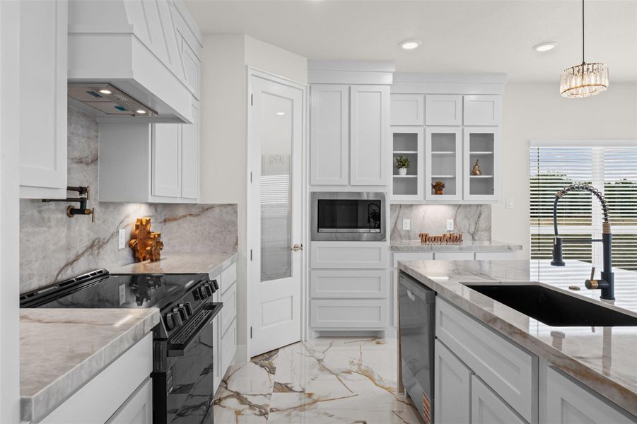 Polished stone counters and gleaming tile floors define this culinary space.