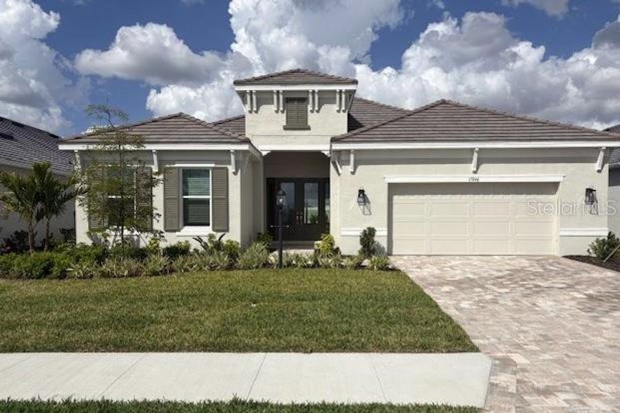 Front exterior of a new home in Esplanade at Azario Lakewood Ranch, Bradenton, FL, highlighting curb appeal (Image 2). Front exterior of a new home in Esplanade at Azario Lakewood Ranch, Bradenton, FL, highlighting curb appeal (Image 2).