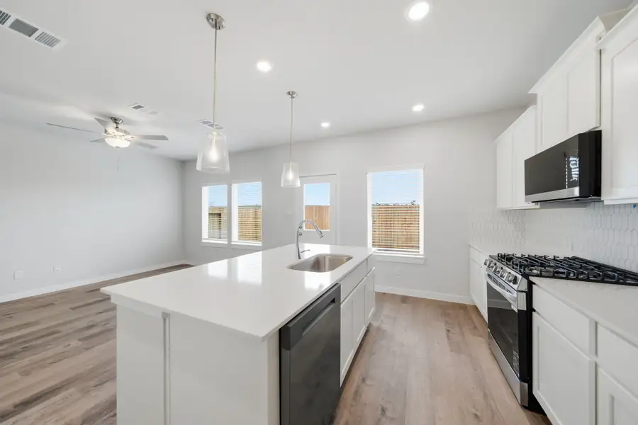A kitchen with white cabinets. A kitchen with white cabinets.