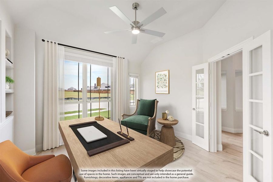Home office with vaulted ceiling, ceiling fan, wood desk, and French doors leading to adjacent room