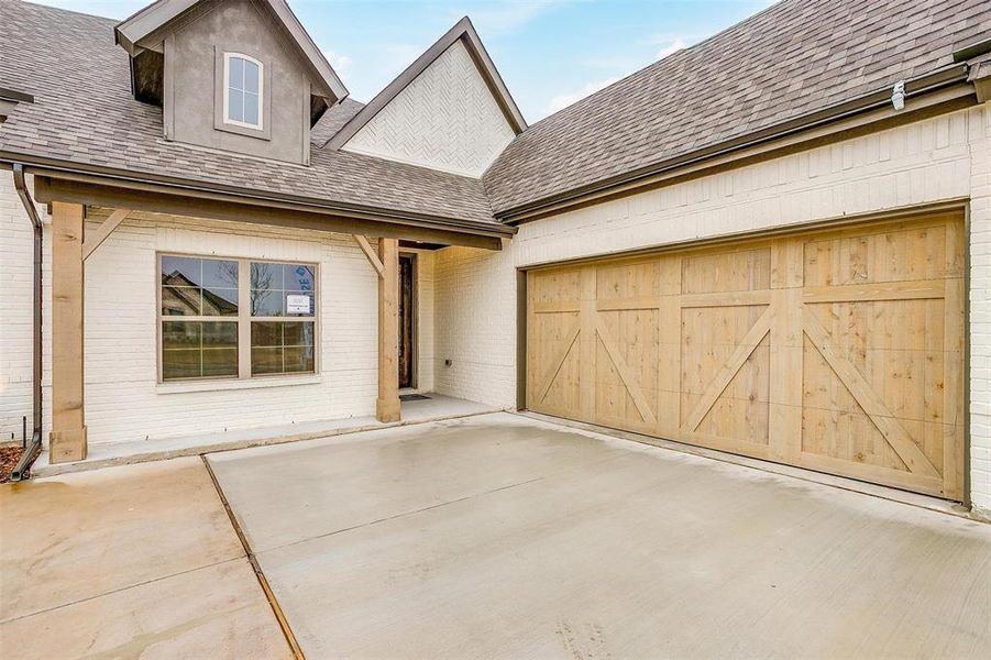 Doorway to property featuring a garage