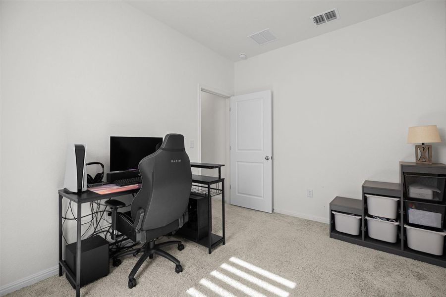 Home office with light carpet and baseboards Home office with light carpet and baseboards
