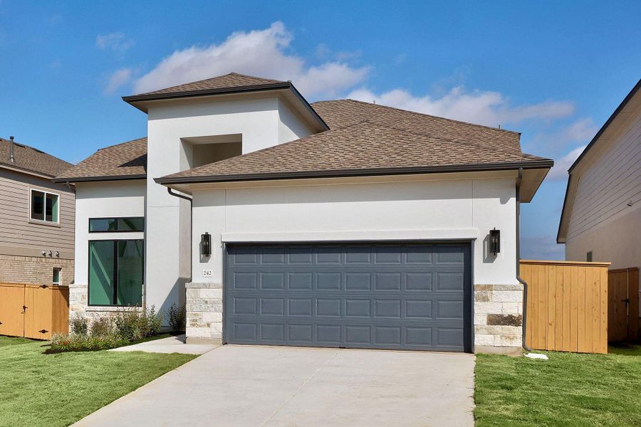 Front exterior of a new home in The Colony, Bastrop, TX, highlighting curb appeal (Image 24).