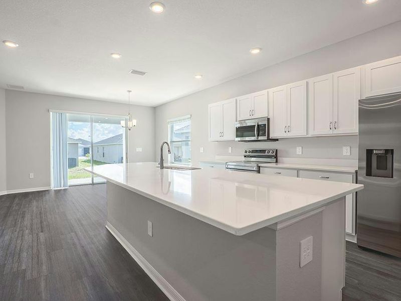 This home features a beautiful kitchen with quartz counters, 36-inch cabinets, and Samsung SS appliances - Photos showcase a home with similar finishes, not the actual home for sale.