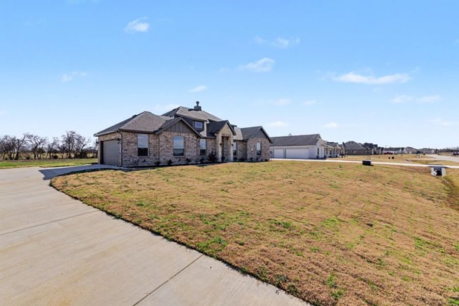 Representative exterior photo of a completed home built from the The Pear by Sumeer Homes in Stone Henge II, Sanger, TX (Image 19). Representative exterior photo of a completed home built from the The Pear by Sumeer Homes in Stone Henge II, Sanger, TX (Image 19).