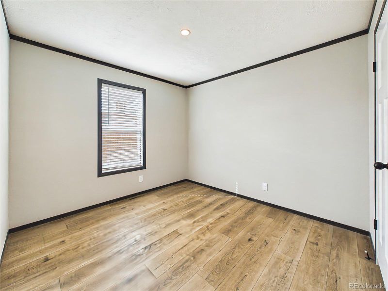 Bedroom 4– Bright and versatile bedroom with wide-plank flooring, neutral tones, and a window that brings in natural light.