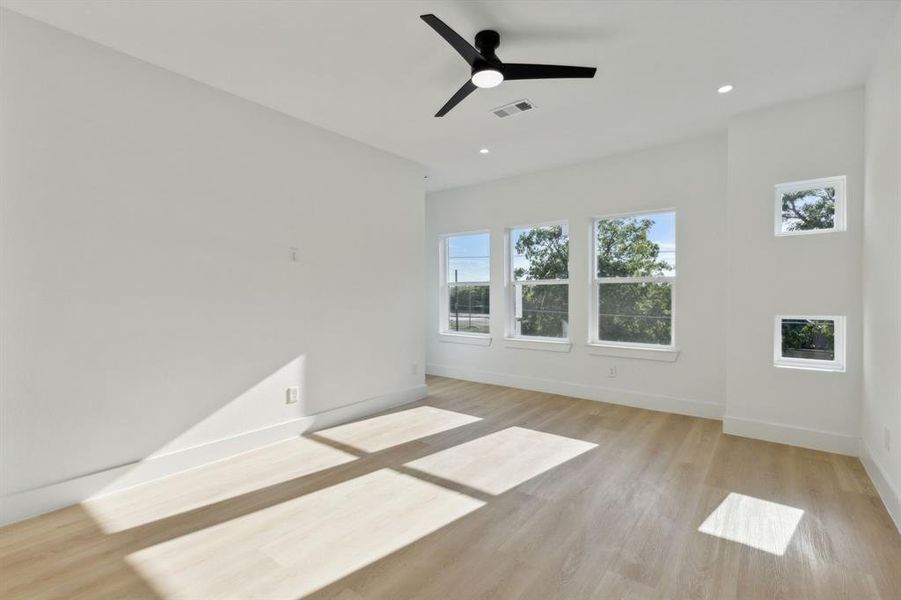 Empty room featuring ceiling fan and light hardwood / wood-style flooring