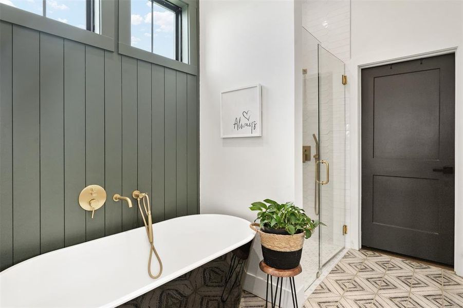 Bathroom featuring a freestanding tub and a stall shower