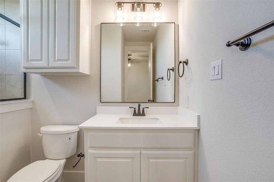 Bathroom with vanity, ceiling fan, and toilet