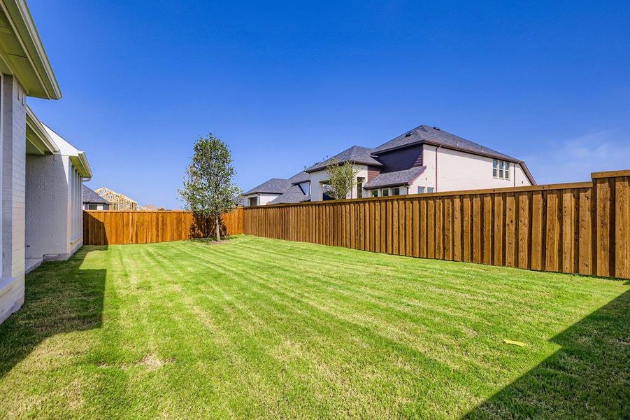 Fenced backyard with a residential view