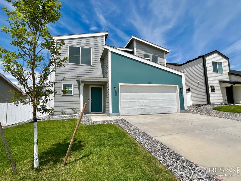 Front exterior of a new home in Liberty Draw, Evans, CO, highlighting curb appeal (Image 1). Front exterior of a new home in Liberty Draw, Evans, CO, highlighting curb appeal (Image 1).