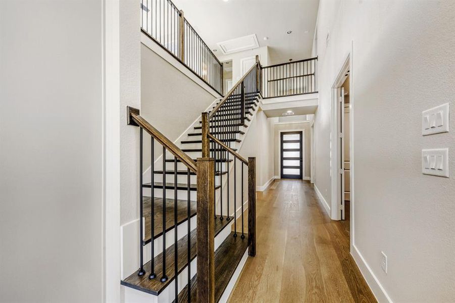 Entrance foyer featuring light wood-type flooring and a high ceiling