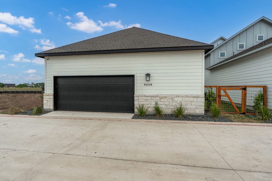 Front exterior of a new home in The Crossvine, Schertz, TX, highlighting curb appeal (Image 23).