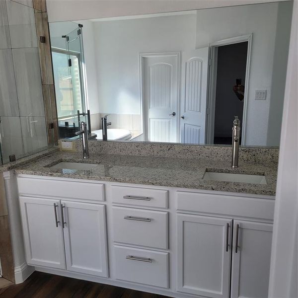 Bathroom featuring wood-type flooring and double sink vanity