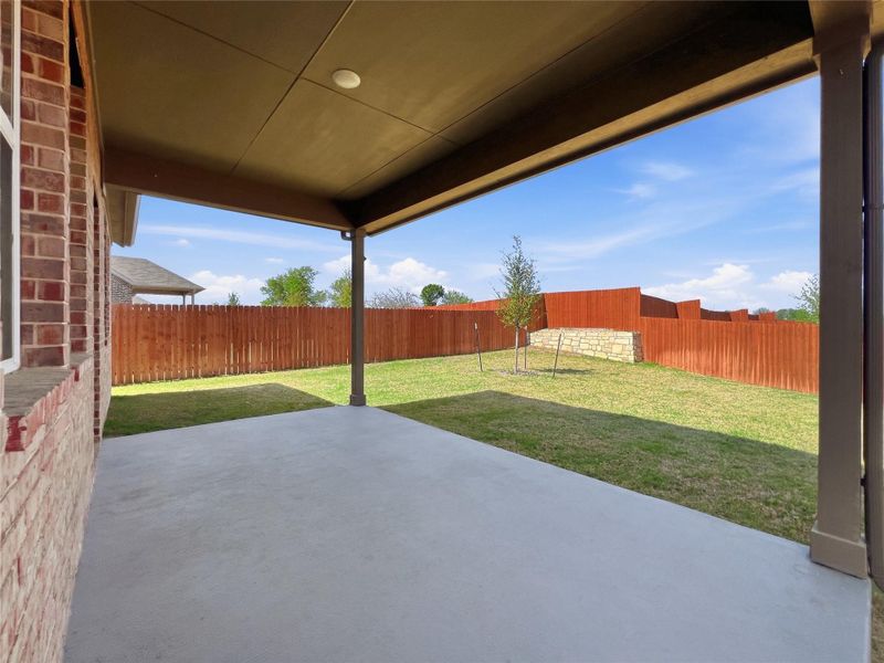 Fenced backyard featuring a patio