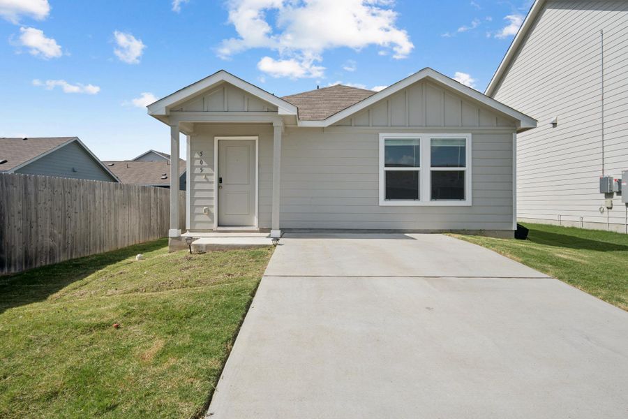 A welcoming front facade with a covered entry and a long driveway offers inviting curb appeal. A welcoming front facade with a covered entry and a long driveway offers inviting curb appeal.