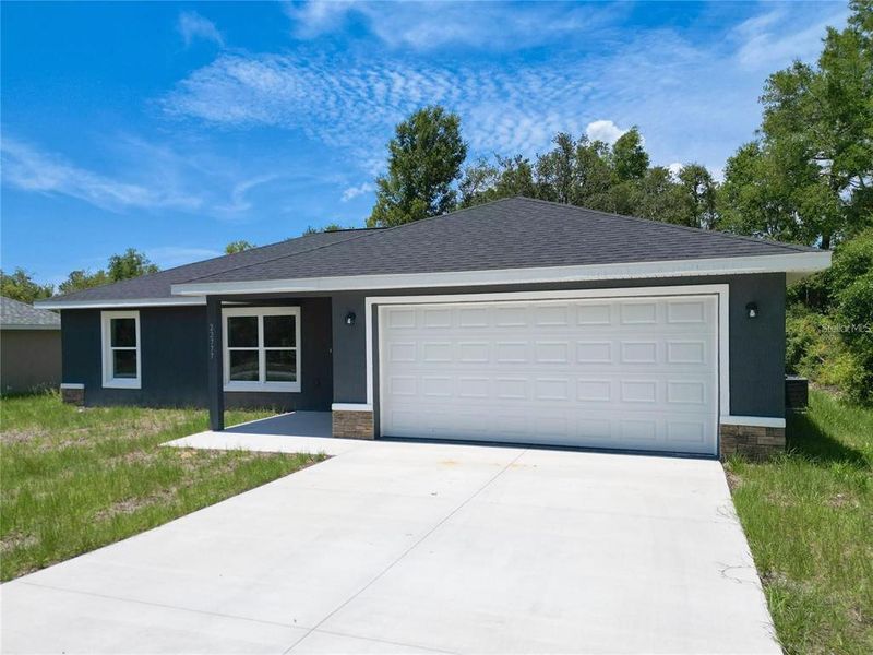 Front exterior of a new home in , Dunnellon, FL, highlighting curb appeal (Image 1).